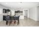 Open dining room with dark wood table and chairs next to the kitchen area at 25951 W Piute Ave, Buckeye, AZ 85396