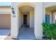 Charming front entrance featuring an arched walkway, well maintained landscaping, and a covered porch at 25951 W Piute Ave, Buckeye, AZ 85396