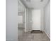 Inviting hallway with tile flooring leading to a bright, open living space at 25951 W Piute Ave, Buckeye, AZ 85396