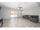 Spacious living room featuring neutral colors, a ceiling fan, and sliding glass doors to the backyard at 25951 W Piute Ave, Buckeye, AZ 85396