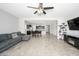 Spacious open concept living room with tile floors flowing into the kitchen and dining areas at 25951 W Piute Ave, Buckeye, AZ 85396