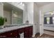 Bathroom featuring a granite countertop vanity and large mirror at 30388 N Opal Dr, San Tan Valley, AZ 85143