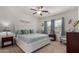 Inviting bedroom with white bed frame, ceiling fan, and window with shade at 30388 N Opal Dr, San Tan Valley, AZ 85143