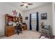 Comfortable bedroom or office with ceiling fan and window view, complemented by a functional desk setup at 30388 N Opal Dr, San Tan Valley, AZ 85143