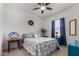 Bright bedroom featuring a ceiling fan, complemented by side tables and decoratively patterned bedding at 30388 N Opal Dr, San Tan Valley, AZ 85143