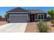 Welcoming single-story home featuring a well-manicured, low-maintenance front yard and a two-car garage at 30388 N Opal Dr, San Tan Valley, AZ 85143