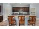 Kitchen with granite countertops, wood cabinets, stainless steel appliances and barstool seating at 30388 N Opal Dr, San Tan Valley, AZ 85143