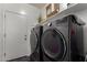 Functional laundry room equipped with a washer and dryer, complemented by storage shelves above at 30388 N Opal Dr, San Tan Valley, AZ 85143