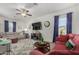 Spacious living room showcasing bright walls, ceiling fan, an oversized rug and comfortable seating at 30388 N Opal Dr, San Tan Valley, AZ 85143