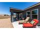 Covered patio with seating, barbecue, and lounge chairs, ideal for relaxing and enjoying the outdoor space at 30388 N Opal Dr, San Tan Valley, AZ 85143