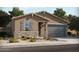 Charming single-story home featuring a stone accent wall and neutral stucco exterior with a two car garage at 311 S San Gregorio Ln, Casa Grande, AZ 85194