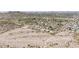 Expansive aerial view captures a desert landscape, mountain views, and a vibrant residential community at 3131 E Las Rocas Dr, Phoenix, AZ 85028