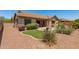 Beautiful backyard showcasing manicured landscaping and a peek of the pool at 3331 N Acacia Way, Buckeye, AZ 85396
