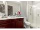 Bright bathroom featuring vanity, shower, and large mirror at 3331 N Acacia Way, Buckeye, AZ 85396
