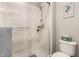 Clean bathroom featuring a bright white shower, toilet, and modern hardware at 3331 N Acacia Way, Buckeye, AZ 85396