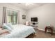 Bedroom with large window and television at 3331 N Acacia Way, Buckeye, AZ 85396