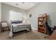 Comfortable bedroom with large bookcase and desk at 3331 N Acacia Way, Buckeye, AZ 85396