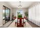 Bright dining room with seating for six, a chandelier, and sliding glass doors at 3331 N Acacia Way, Buckeye, AZ 85396