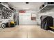 Organized garage with overhead storage racks, built-in cabinets, and epoxy floors at 3331 N Acacia Way, Buckeye, AZ 85396