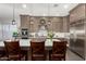 A closer view of the gourmet kitchen with an island and stainless steel fridge at 3331 N Acacia Way, Buckeye, AZ 85396