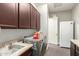 Spacious laundry room with modern appliances, cabinets, and a utility sink at 3331 N Acacia Way, Buckeye, AZ 85396