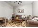 Comfortable living room with a plush sofa, area rug, and a neutral color palette at 3331 N Acacia Way, Buckeye, AZ 85396