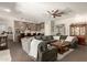 Open-concept living room and kitchen with large sectional sofa at 3331 N Acacia Way, Buckeye, AZ 85396