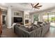 Spacious living room features a large sectional sofa, fireplace, and seamless access to the outdoor patio at 3331 N Acacia Way, Buckeye, AZ 85396