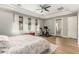 Comfortable main bedroom featuring tray ceiling, natural light, and exercise equipment at 3331 N Acacia Way, Buckeye, AZ 85396