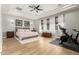 Spacious main bedroom with decorative tray ceiling and wood floors at 3331 N Acacia Way, Buckeye, AZ 85396