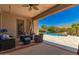 Inviting patio with comfortable seating, a ceiling fan, and a view of the pool at 3331 N Acacia Way, Buckeye, AZ 85396