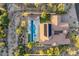 Beautiful aerial view of the home showcasing a pristine pool, spa, solar panels, patio, lush landscaping, and a backyard at 35556 N 87Th Pl, Scottsdale, AZ 85266