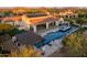 Aerial view of the property showcasing the pool, spa, covered patio, and desert landscaping at 35556 N 87Th Pl, Scottsdale, AZ 85266