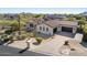 An aerial view of the desert home showcasing its roof, solar panels, and landscaped front yard at 35556 N 87Th Pl, Scottsdale, AZ 85266