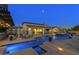 Resort-style backyard featuring a pool with fountains, lounging areas, and lush desert landscaping at 35556 N 87Th Pl, Scottsdale, AZ 85266