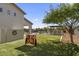 Spacious backyard with manicured lawn, a giant connect four game, and outdoor living areas for entertainment at 35556 N 87Th Pl, Scottsdale, AZ 85266