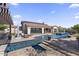Resort-style backyard with a sparkling pool, multiple seating areas, and lush landscaping for ultimate relaxation at 35556 N 87Th Pl, Scottsdale, AZ 85266