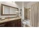 Well-lit bathroom with granite counters, framed mirror, and a shower-tub combo at 35556 N 87Th Pl, Scottsdale, AZ 85266