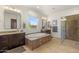 Elegant bathroom featuring a soaking tub, granite countertops, a walk-in shower, and wood cabinets at 35556 N 87Th Pl, Scottsdale, AZ 85266