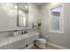 Stylish powder room featuring a marble countertop, modern fixtures, and decorative accents at 35556 N 87Th Pl, Scottsdale, AZ 85266