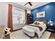 Charming bedroom with soccer themed decorations, a large window, and light-colored carpet at 35556 N 87Th Pl, Scottsdale, AZ 85266