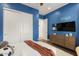 Bright bedroom with blue walls, white trim, and large closet is nicely decorated at 35556 N 87Th Pl, Scottsdale, AZ 85266