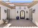 An inviting courtyard with seating, charming décor, and access to the home through an ornate wrought-iron door at 35556 N 87Th Pl, Scottsdale, AZ 85266