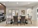 Elegant dining area with a wooden table, stylish chairs, and an abundance of natural light for a warm ambiance at 35556 N 87Th Pl, Scottsdale, AZ 85266
