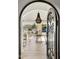 Through the wrought-iron gate, the entrance reveals an open living space with stylish furnishings and outdoor views at 35556 N 87Th Pl, Scottsdale, AZ 85266