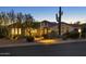 Charming home exterior showcasing desert landscaping, arched entry, and warm exterior lighting at 35556 N 87Th Pl, Scottsdale, AZ 85266
