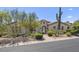 Exterior view of a charming desert home with stone accents and beautiful landscaping at 35556 N 87Th Pl, Scottsdale, AZ 85266