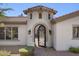 The front of the house boasts a decorative doorway, tile roof, and manicured landscaping at 35556 N 87Th Pl, Scottsdale, AZ 85266