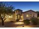 Beautiful home with a tower entrance, desert landscaping, and a paver walkway at 35556 N 87Th Pl, Scottsdale, AZ 85266