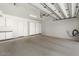 Clean and spacious garage with epoxy floors, storage cabinets, and EV charging outlet at 35556 N 87Th Pl, Scottsdale, AZ 85266